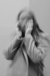 a woman with blurred face experiencing panic attack